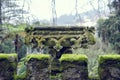 Architecture outdoor details and elements of Quinta da Regaleira. Close up view of the old stone vase with green moss