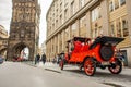 Architecture of Prague old town with red retro car on the street. Gunpowder tower