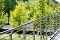 Architecture, railing on tree-lined park. Royalty Free Stock Photo