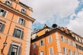 Architecture of Rome. A building with the characteristic ocher facade and green windows. Trastevere district Royalty Free Stock Photo