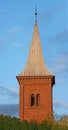 Architecture roof design of church steeple and spire on gothic style cathedral building against blue sky. Tall Royalty Free Stock Photo