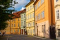 The architecture of the strago city of Prague. Multi-colored low buildings and stone paving stones. Streets of old Europe