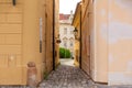 The architecture of the strago city of Prague. Old european streets, yellow low buildings and stone paving stones