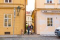 The architecture of the strago city of Prague. Old european streets, yellow low buildings and stone paving stones