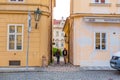 The architecture of the strago city of Prague. Old european streets, yellow low buildings and stone paving stones