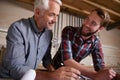 Architecture, teamwork and man with apprentice in workshop for collaboration. Senior engineer, men and smile with Royalty Free Stock Photo