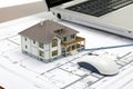 Architecture Web. 3D Rendering of a Residential Architecture Model on Top of Blueprints Connected to a Computer Mouse Royalty Free Stock Photo