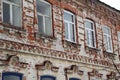 Old two-story house with ragged brick walls Royalty Free Stock Photo