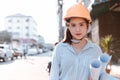 Architecture woman hold blueprints design plan and wearing safety helmet at site construction in hot weather day. Architecture, Royalty Free Stock Photo