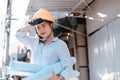 Architecture woman hold blueprints design plan and wearing safety helmet at site construction in hot weather day. Architecture, Royalty Free Stock Photo