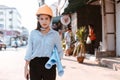 Architecture woman hold blueprints design plan and wearing safety helmet at site construction in hot weather day. Architecture, Royalty Free Stock Photo