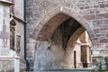 an arch in an old brick building with two windows and green vines on the door Royalty Free Stock Photo