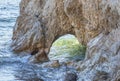 Archway in a rock formation on the shoreline
