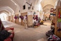 Archway with a variety of market stalls and beds