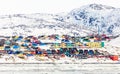 Arctic city center panorama with colorful Inuit houses on the rocky hills covered in snow with snow and mountain in the background Royalty Free Stock Photo