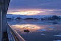 Arctic Glow reflecting in Whalers Bay, Deception Island, Antarctica with Zodiac and ship deck Royalty Free Stock Photo