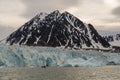 Arctic landscape people in the zodiac approach the glacier descending to the Gulf