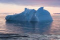 Arctic nature landscape with icebergs in Greenland icefjord with midnight sun sunset / sunrise in the horizon. Early morning