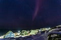 Arctic polar night over colorful inuit houses with small northern light in a suburb of arctic capital Nuuk, Greenland Royalty Free Stock Photo