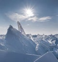 Arctic winter landscape, cold sun over ice hummocks in snow Royalty Free Stock Photo