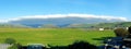 Arcus cloud formation in the form of shelf or rolling clouds over rural mountain landscape