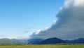 Arcus cloud formation in the form of shelf or rolling clouds over rural mountain landscape Royalty Free Stock Photo