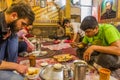 ARDABIL, IRAN - APRIL 10, 2018: People eat Dizi Abgoosht , traditional Iranian stew, in a local restaurant in Ardabil