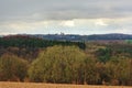 Ardennes landscape,with empty winter farmland and mixed forests and hills on a rainy day with dark clouds Royalty Free Stock Photo