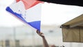 Ardent football fans waving national team flag, watching broadcast on big screen