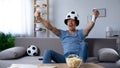 Ardent football supporter in fan hat rejoicing to scored penalty kick, victory Royalty Free Stock Photo