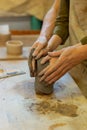 Ardent young couple having romantic masterclass in pottery workshop