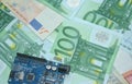 Arduino DIY board on euro banknote background. The concept of modernity,