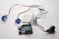 Arduino uno board connected to micro servo and joystick using jumper wires and breadboard. Arduino Uno project prototyping Royalty Free Stock Photo