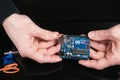 Arduino UNO board holding in hands