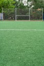 Area of artificial turfed playing field with goal and protective grid for ball catching Royalty Free Stock Photo