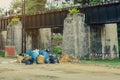 The area that dumped garbage under The Bridge of the River Kwai in Kanchanaburi, Thailand. pollution garbage waste, lots of junk