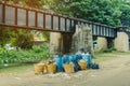 The area that dumped garbage under The Bridge of the River Kwai in Kanchanaburi, Thailand. pollution garbage waste, lots of junk