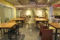 area modern co working space with brown chair,wood table,green leaf bright modern working space with blurred