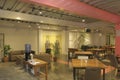 area modern co working space with brown chair,wood table,green leaf bright modern working space with blurred