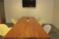 area modern co working space with brown chair,wood table,green leaf bright modern working space with blurred