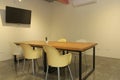 area modern co working space with brown chair,wood table,green leaf bright modern working space with blurred