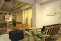 area modern co working space with brown chair,wood table,green leaf bright modern working space with blurred