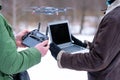 Area planners survey the surroundings with a drone, hands with drone remote controller and a laptop