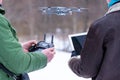 Area planners survey the surroundings with a drone, hands with drone remote controller and a laptop