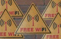 Area signs to use free Wi-Fi. Sign free wi-fi metal plate of yellow color on a brick wall