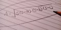 area of square equation written on page with pencil pointer Royalty Free Stock Photo