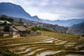 An areal view of a rural landscape lined with small, rustic houses: Sapa, Northern Vietnam