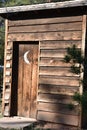 Vintage wooden outhouse with crescent moon on door Royalty Free Stock Photo