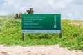 Sign marking a sea turtle nest at the beach in Arembepe, Bahia state