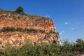 Arenite rock, in Jalapao, Brazil, contrasting with the blue sky and green fields.